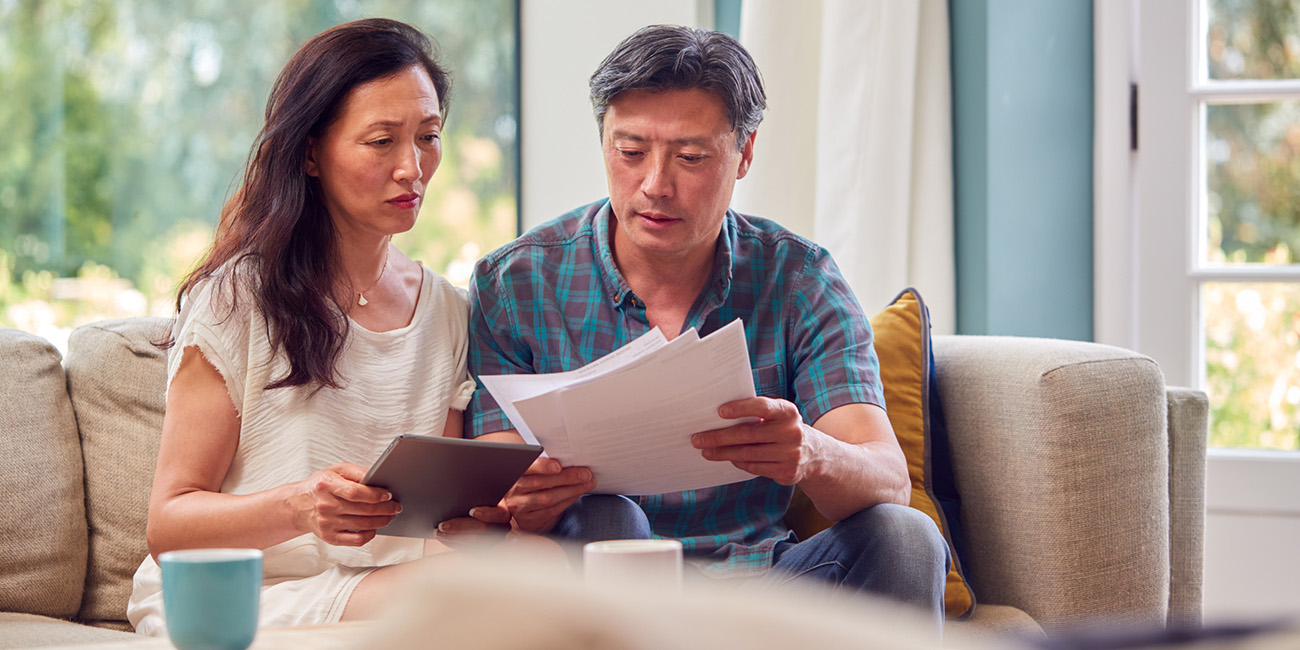 AOT-August-SEO-Insurance Couple going over paperwork