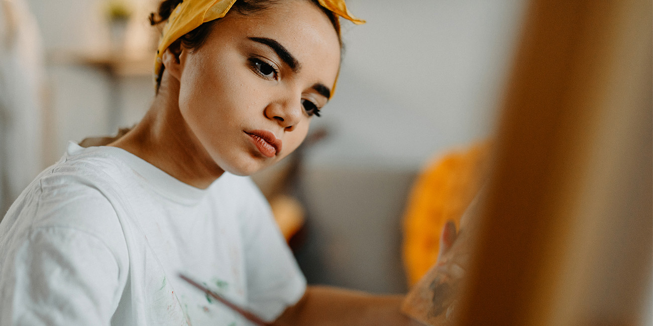 Girl hyper focused on her painting