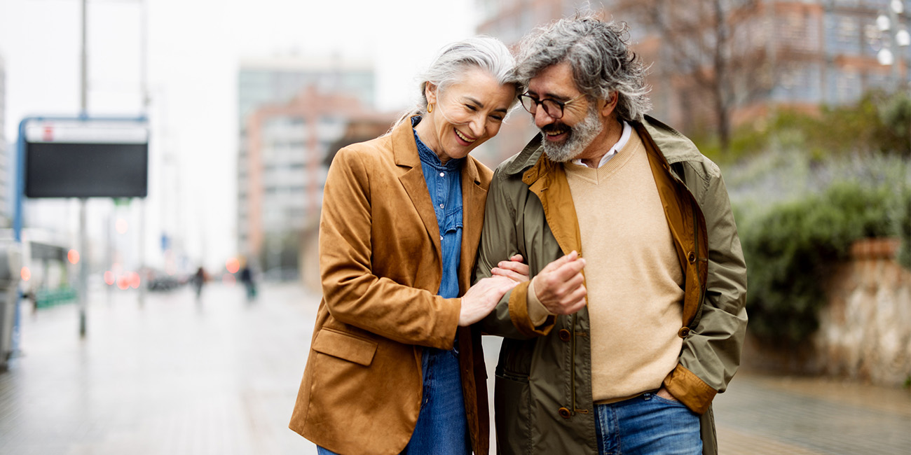 AOT-Feb-RelationshipsandAttachments Older couple walking outside, holding hands